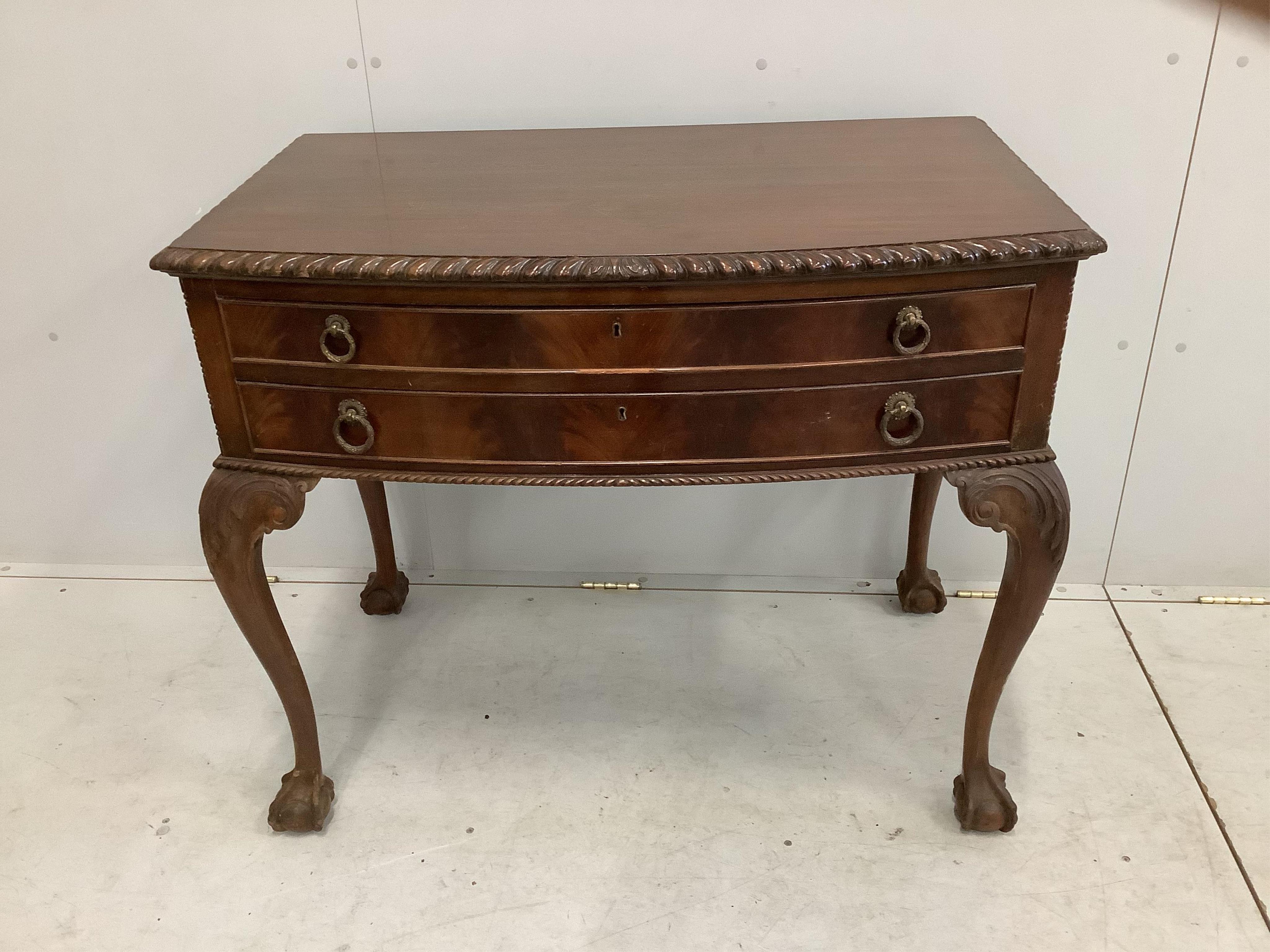 A Chippendale Revival mahogany dining suite comprising extending dining table, 210cm extended, two spare leaves, depth 106cm, height 75cm, bowfront sideboard and serving table, together with six dining chairs (two with a